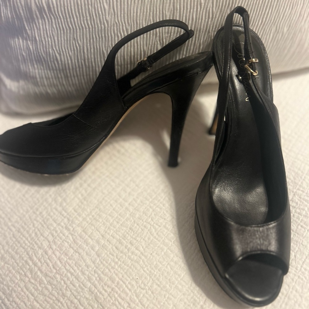 Timeless Cole Haan black leather peep toe, sling back heels.